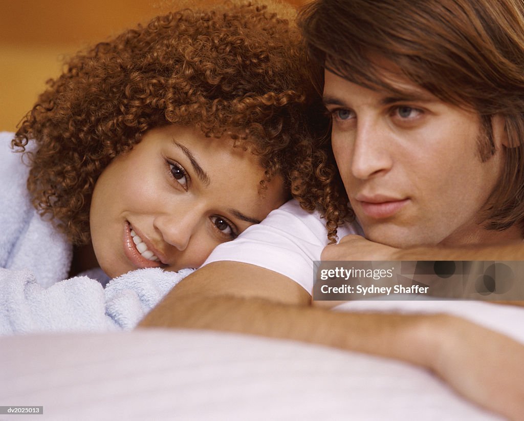 Portrait of a Couple Lying Side by Side, Woman Smiling at the Camera