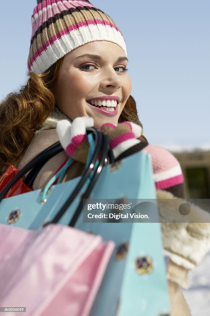 Portrait of a Young Woman Carrying Shopping Bags