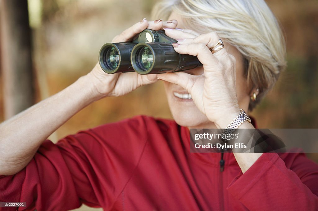 Mature Woman Looking Through Binoculars