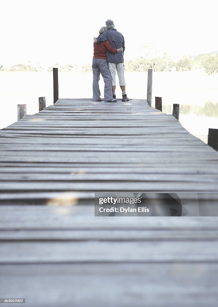 Rear View of an Embracing Couple Standing on a Pier