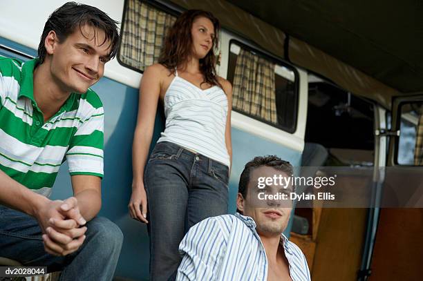 two young men and a woman by a motor home - ellis stock-fotos und bilder