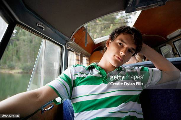 thoughtful, young man sitting in a motor home - ellis stock-fotos und bilder