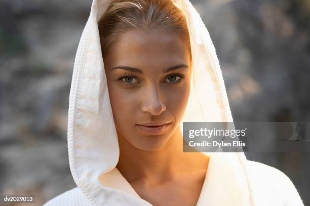 portrait of a young woman wearing a hooded bathrobe - ellis stock-fotos und bilder