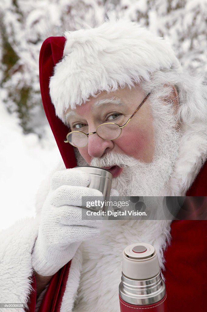 Portrait of Father Christmas Drinking From a Vacuum Flask