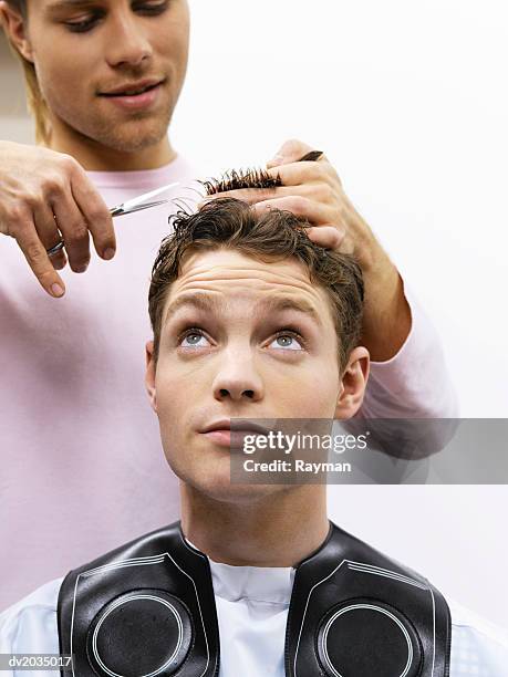 hairdresser cutting a man's hair - beauty care occupation stock pictures, royalty-free photos & images