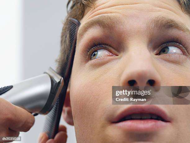 close up of a man having his hair cut - beauty care occupation stock pictures, royalty-free photos & images