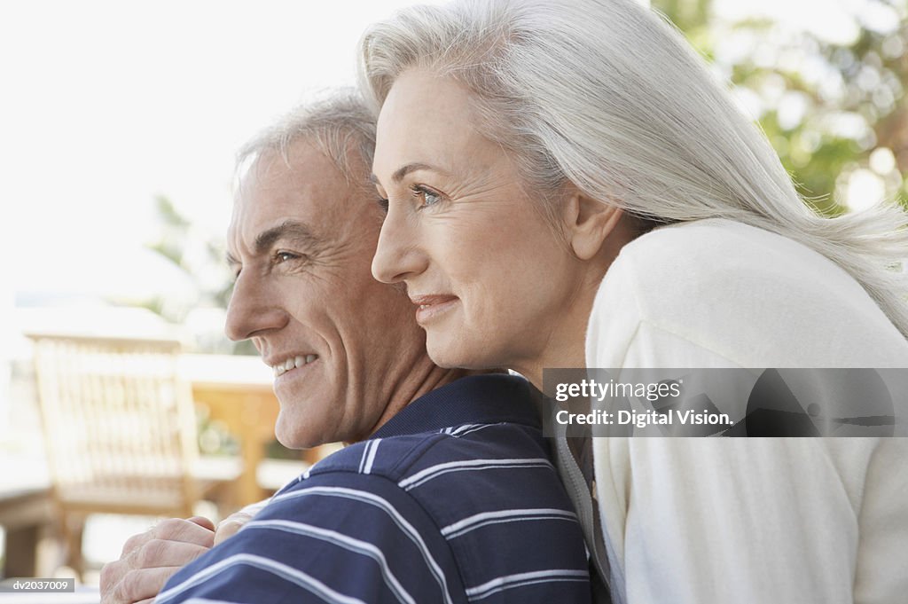 Senior Woman Standing Closely Behind a Senior Man