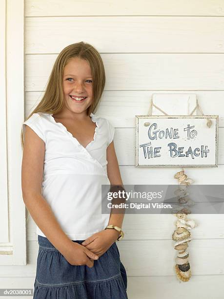 young girl standing by a sign on wooden house - digital devices beside each other bildbanksfoton och bilder