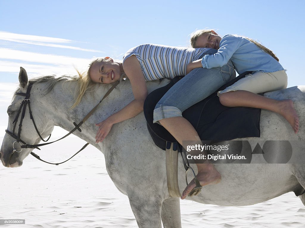 Mother and Daughter Riding a White Horse