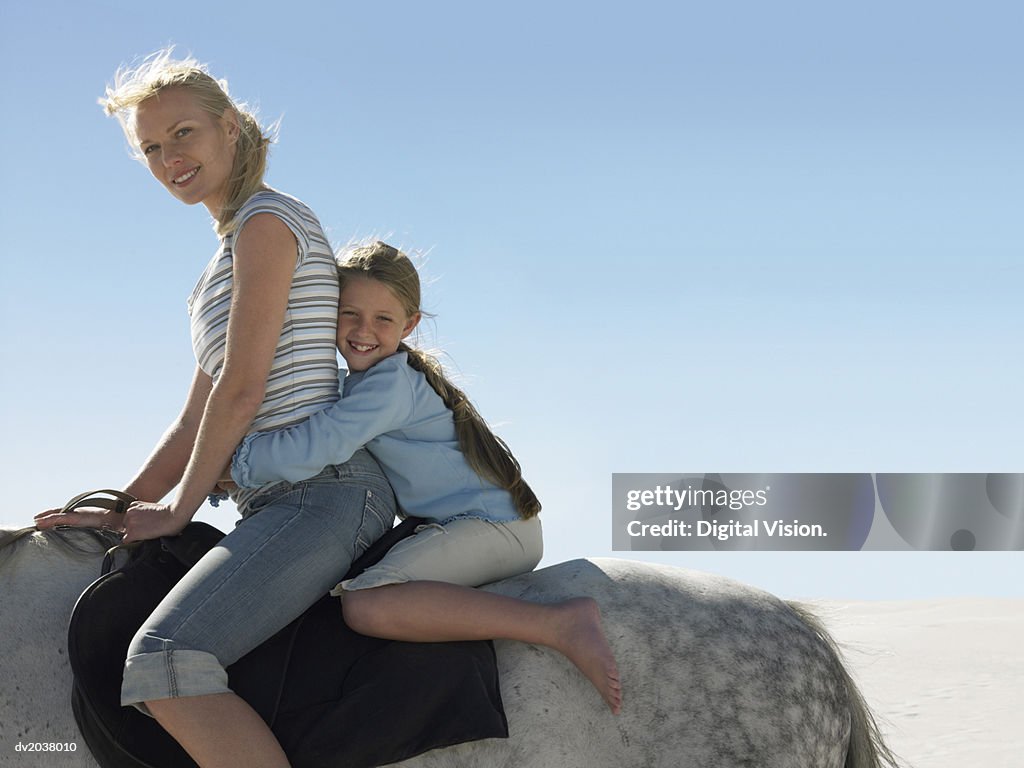 Portrait of a Woman Riding a White Horse With Her Daughter