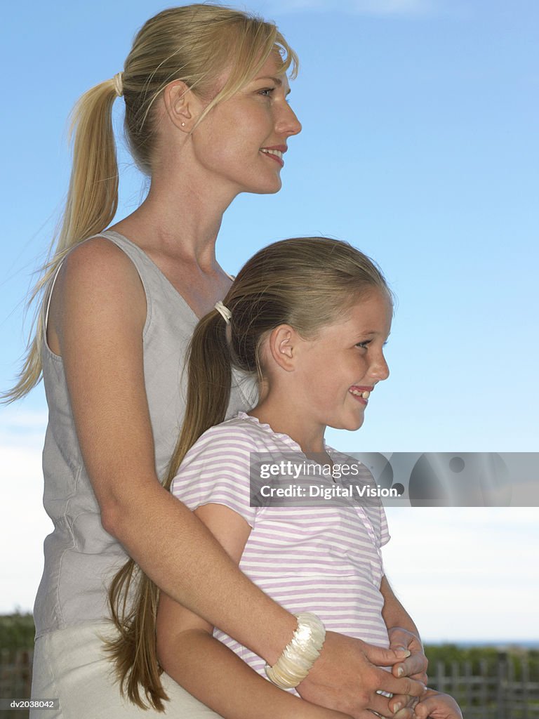Portrait of a Mother and Daughter Embracing