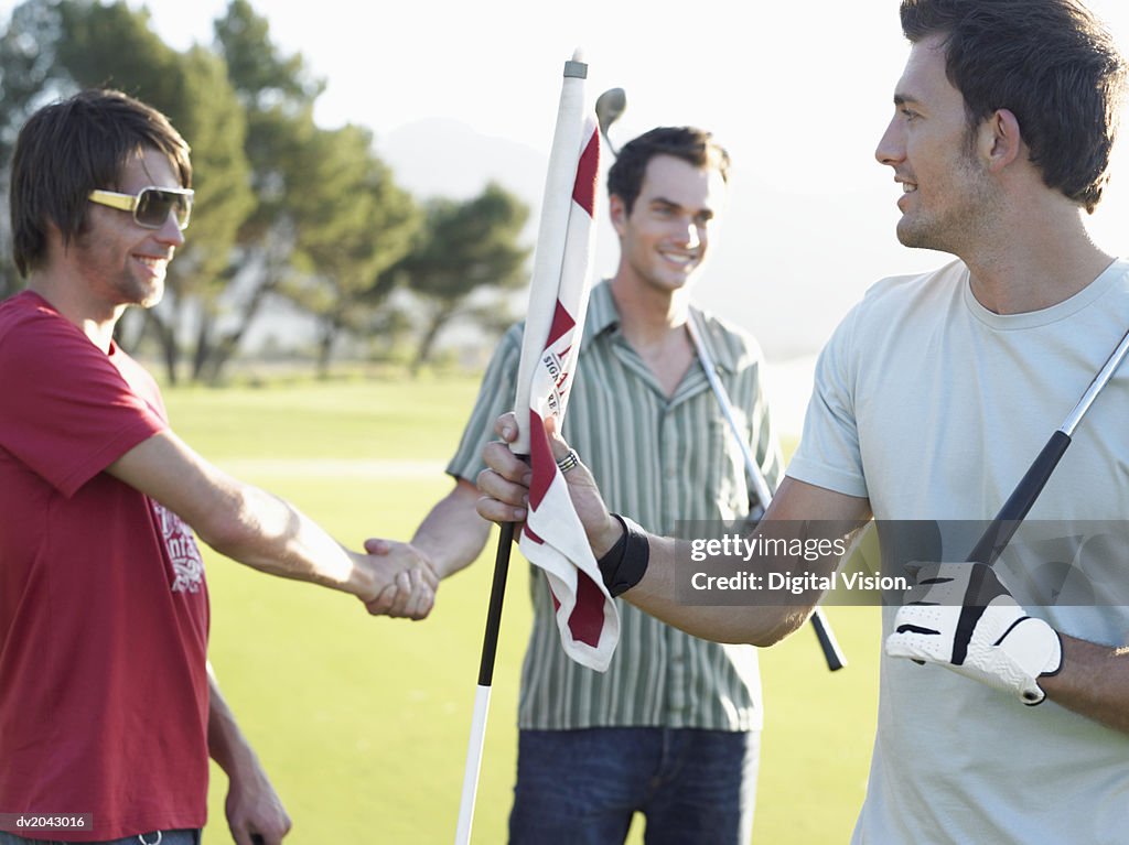 Friends Shaking Hands on a Golf Course