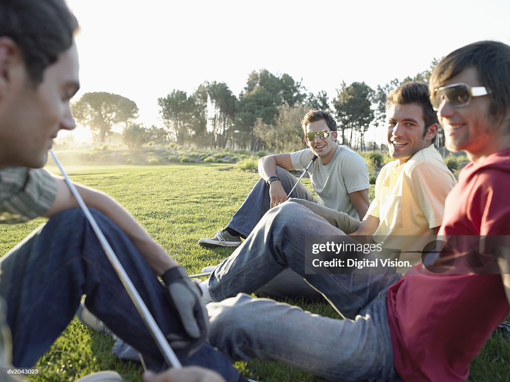 Four Friends Sitting Together on a Golf Course