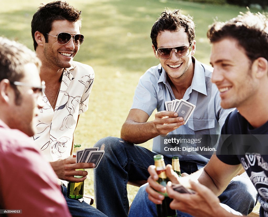 Group of Men Playing Cards and Drinking Beer