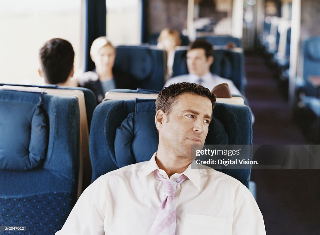 Businessman Sitting on a Passenger Train