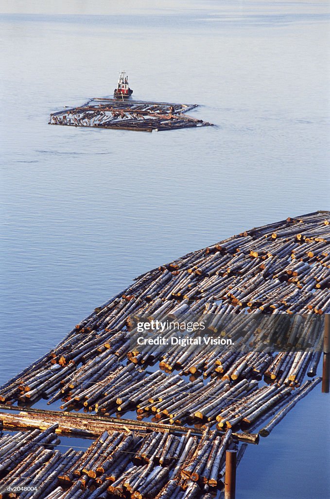 Tug Hauling Logs on a River