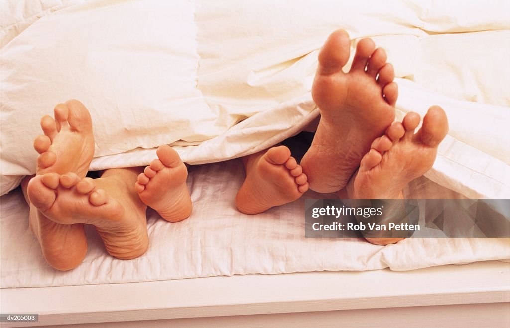 Feet sticking out of bed