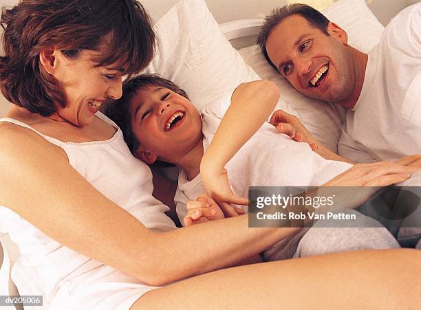 family lying in bed - kids in undies stock pictures, royalty-free photos & images