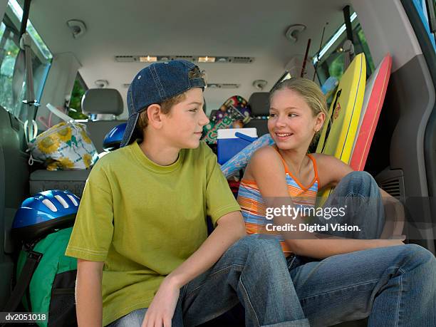 brother and sister sitting in an suv car - messy car interior stock pictures, royalty-free photos & images