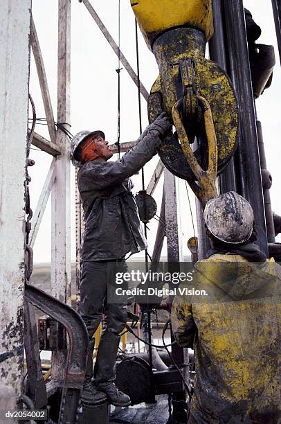 Man Riding On Rigs 126 Two Men Working On An Oil Rig Stock Photos, High-Res Pictures, and ...