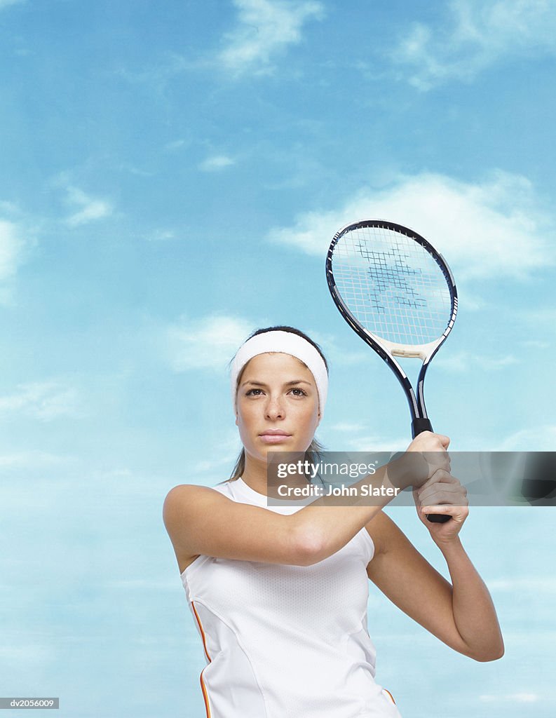 Portrait of a Tennis Player Holding Her Racket in the Air