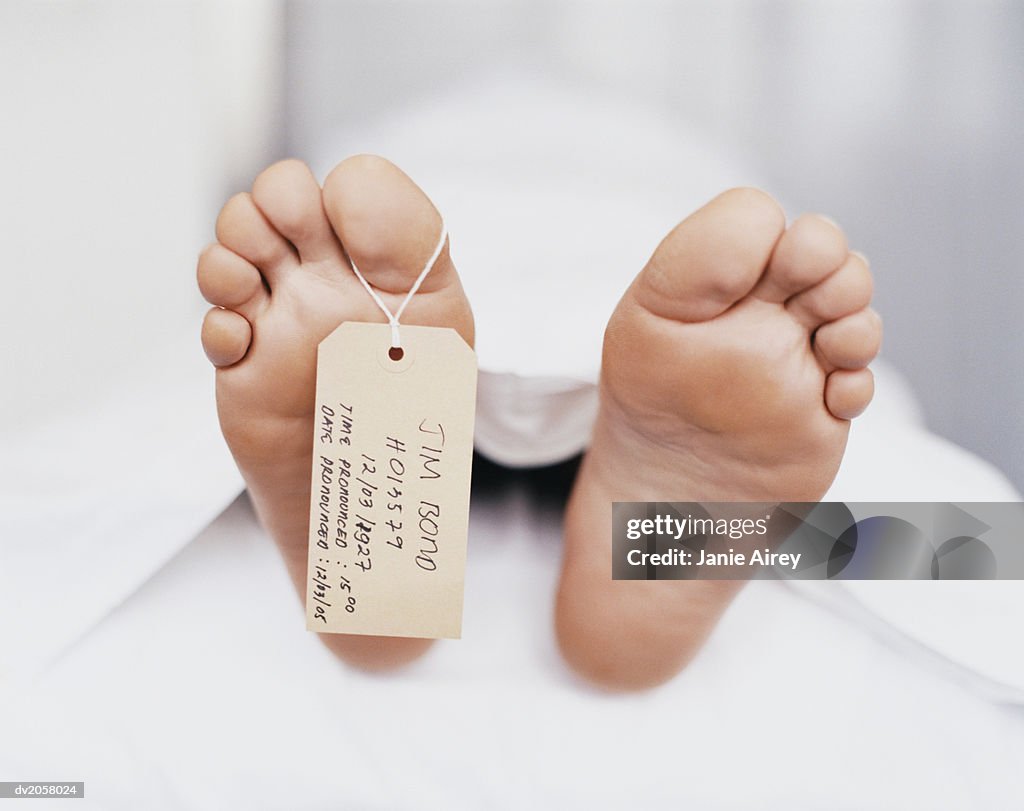 Name Tag Hanging From the Foot of a Dead Body Under a Sheet