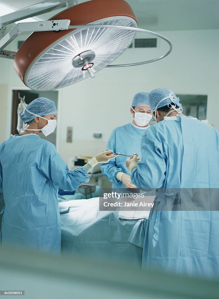 Three Surgeons Operating on a Patient