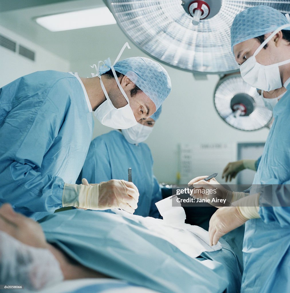 Three Surgeons Operating on a Patient