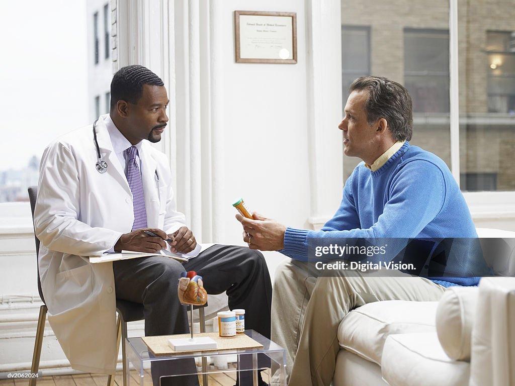 Doctor Discussing Medicine in His Clinic With a Patient