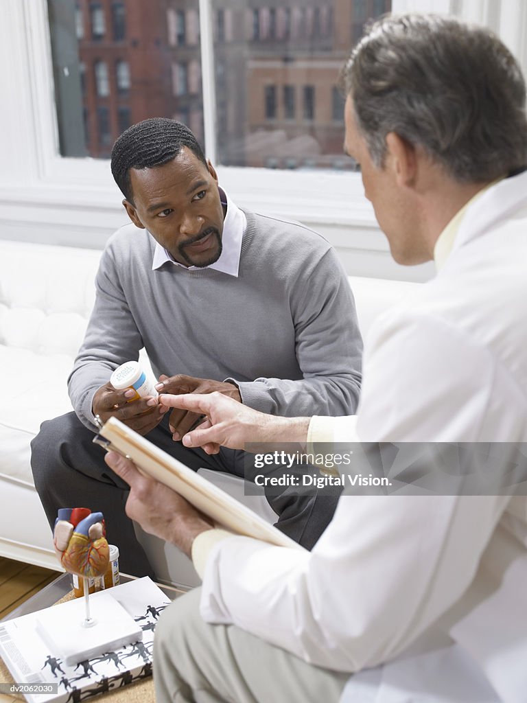 Doctor Giving an Explanation About the Medicine Given to a Male Patient