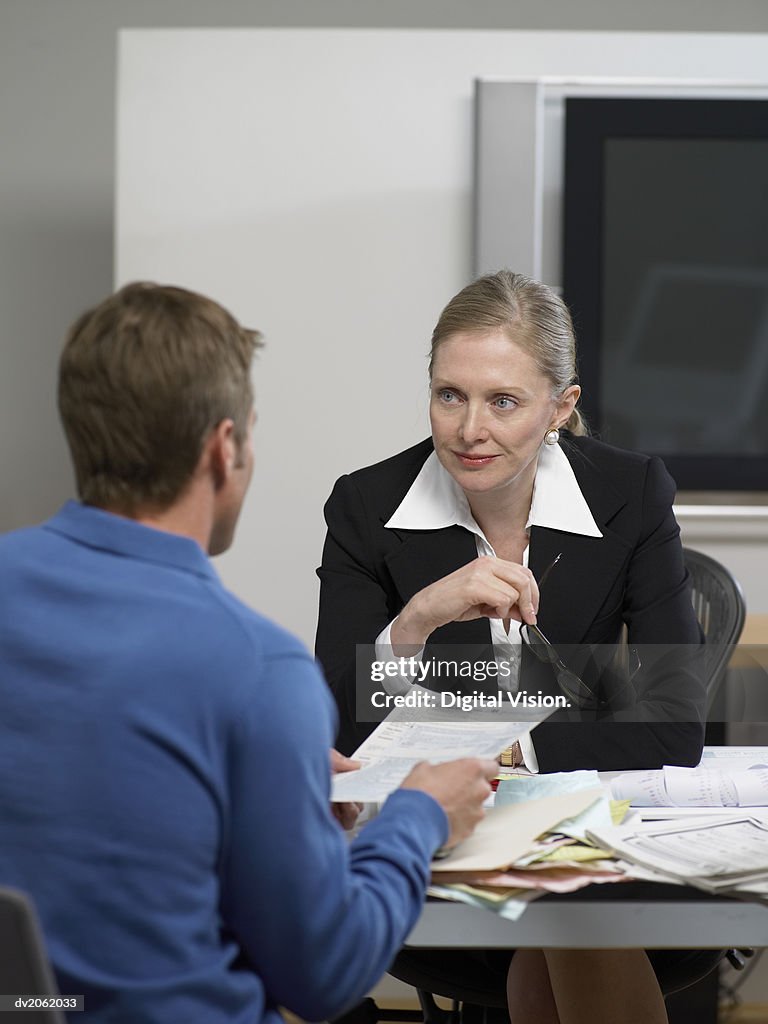 Female Doctor Listening to a Male Patient's Explanations