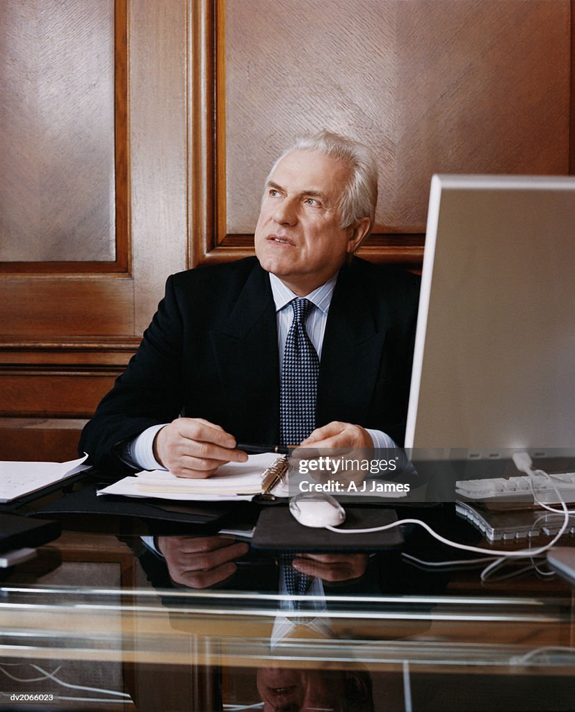 Senior CEO Sitting at His Desk