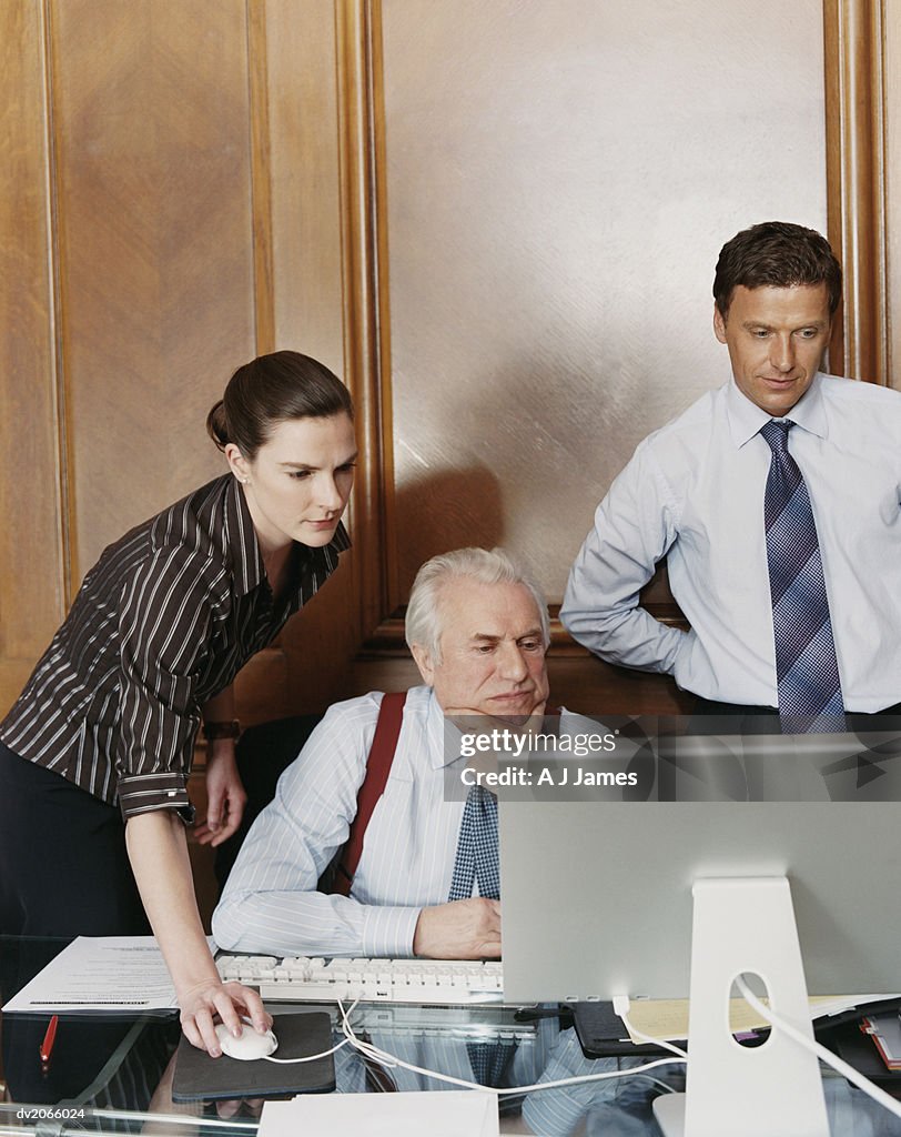 Business Executives Working Around a CEO's Desk