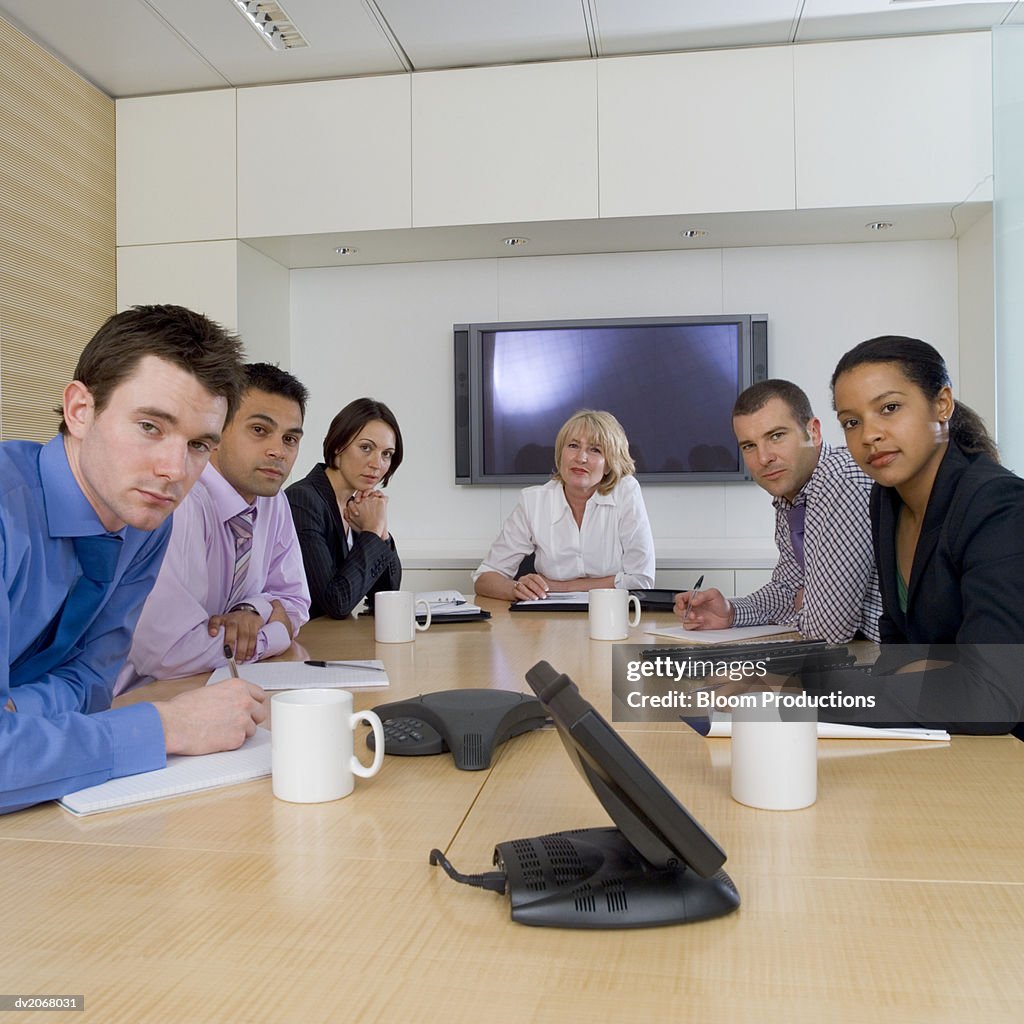 Businesspeople Sitting Around a Conference Table