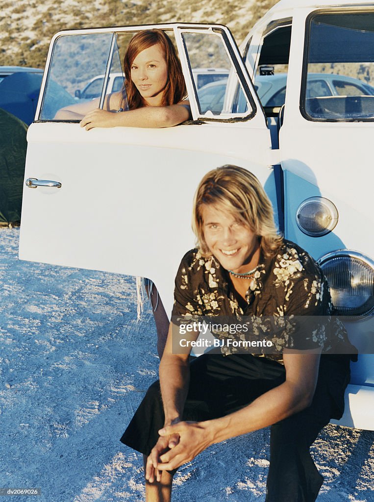 Couple Sitting by a Camping Van