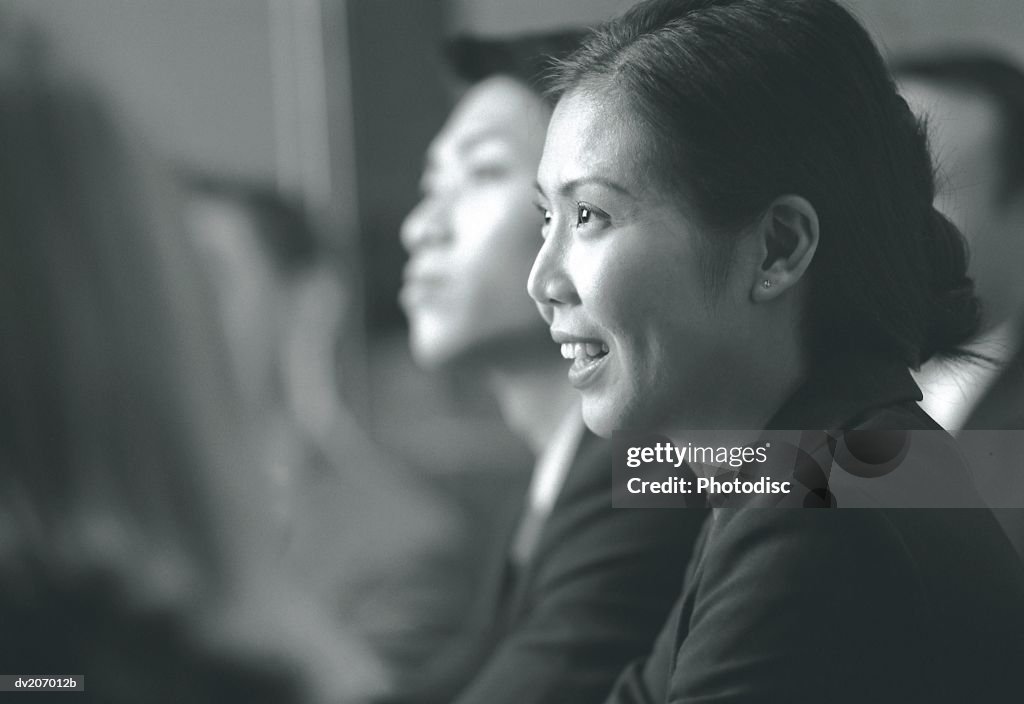 Asian woman talking during meeting