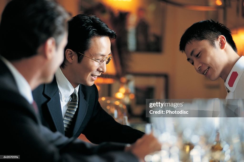 Businessmen sitting at bar