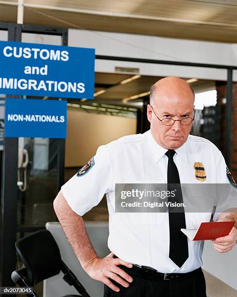 passport officer at airport security - western script stock pictures, royalty-free photos & images