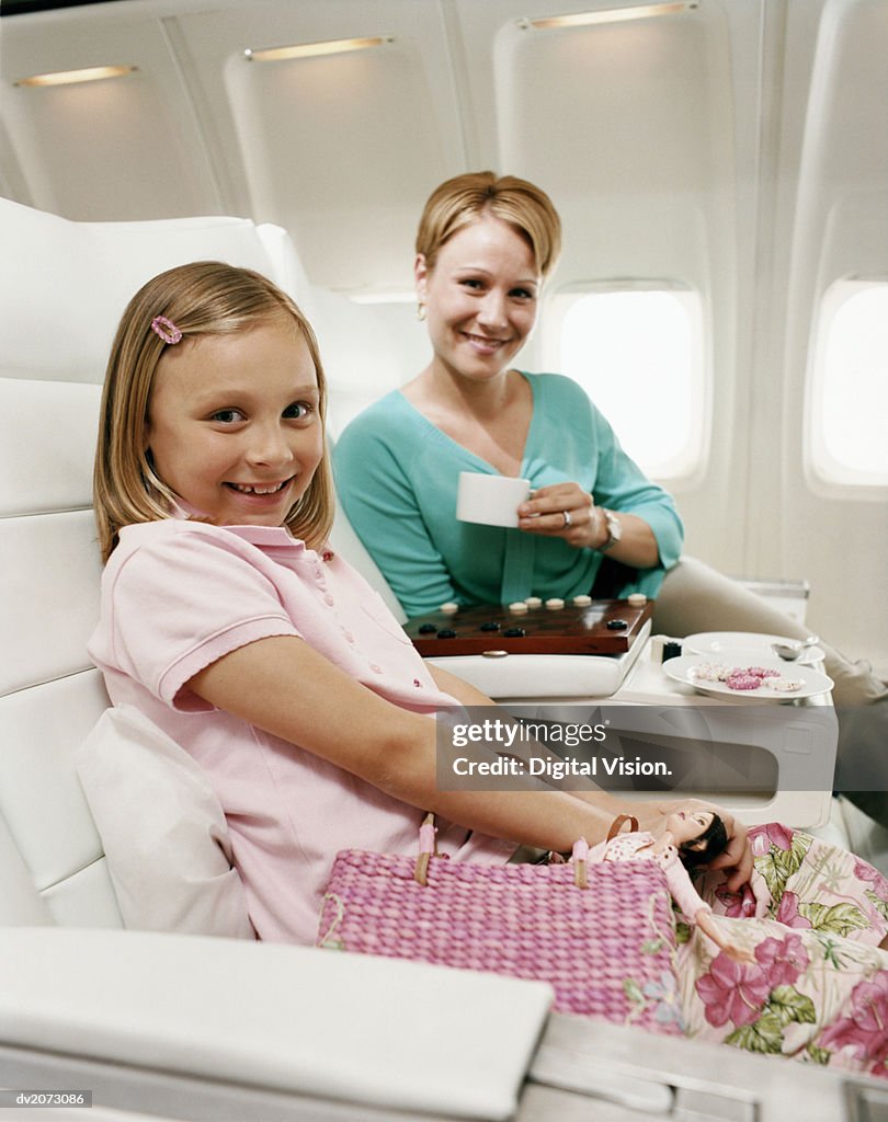 Mother and Daughter Sitting in an Aircraft Cabin
