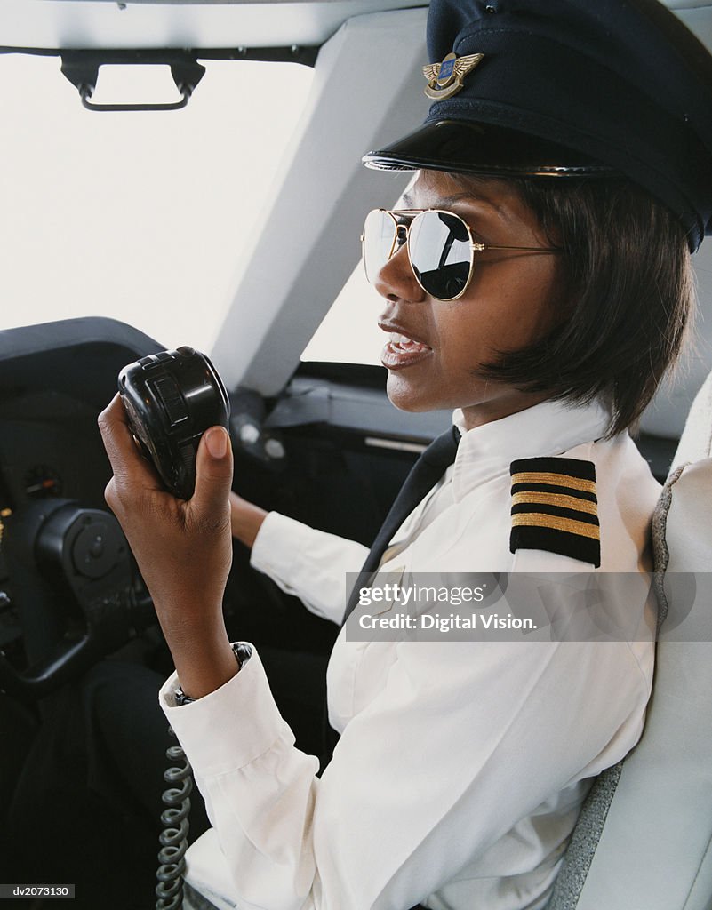 Female Pilot Talking into a Radio