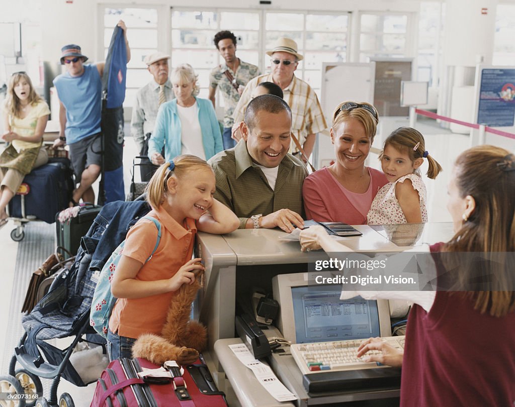 Family With Two Young Children Checks in at an Airport