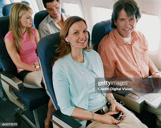 passengers on a plane - raamplaats stockfoto's en -beelden