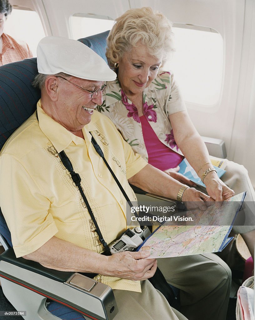 Senior Couple Looking at a Map on a Plane