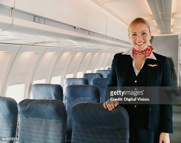 portrait of a female flight attendant on a plane - crew stock pictures, royalty-free photos & images