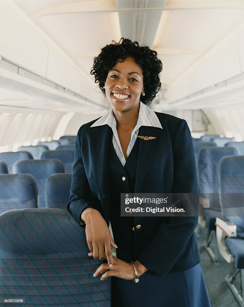 Portrait of a Smiling Female Flight Attendant on a Plane