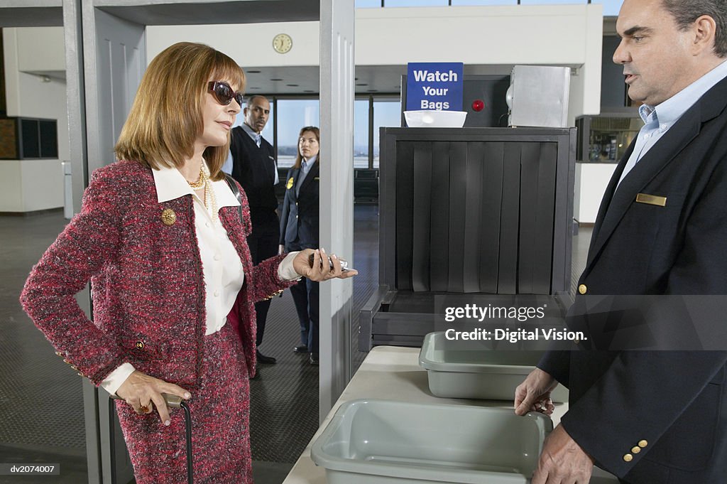 Well Dressed Woman Looking Impatiently at an Airport Customs Officer