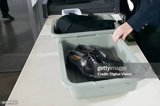 shoes and clothes in containers on a table at airport customs - customs agent stock pictures, royalty-free photos & images