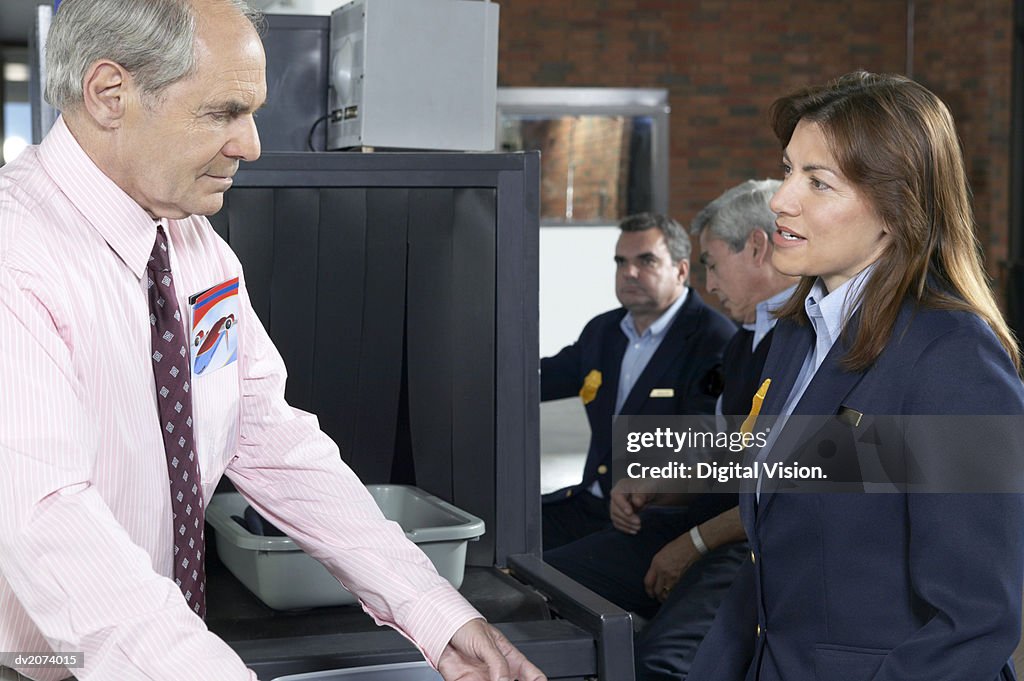 Man Talking to Customs Officers in an Airport