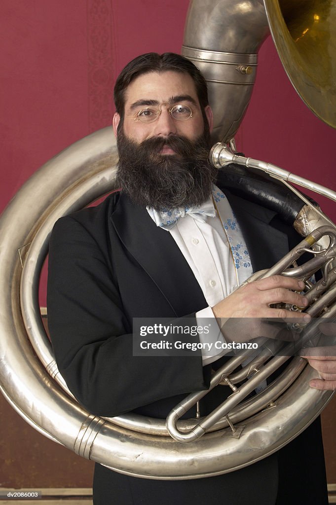 Portrait of a Male Tuba Player in an Old-Fashioned Suit