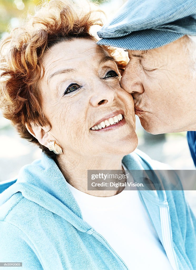 Senior Couple, Man Kissing the Woman's Cheek